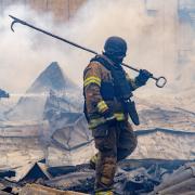 Rescuers work on the roof of a damaged building following Russia’s air attack in Kharkiv, Ukraine (Andrii Marienko/AP)
